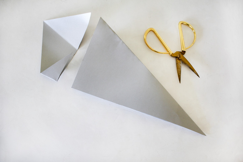 Cutting off part of paper to make Christmas star