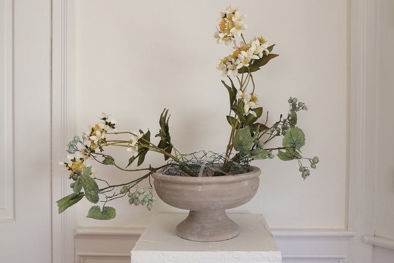 Green weathered berry branches placed inside chicken wire