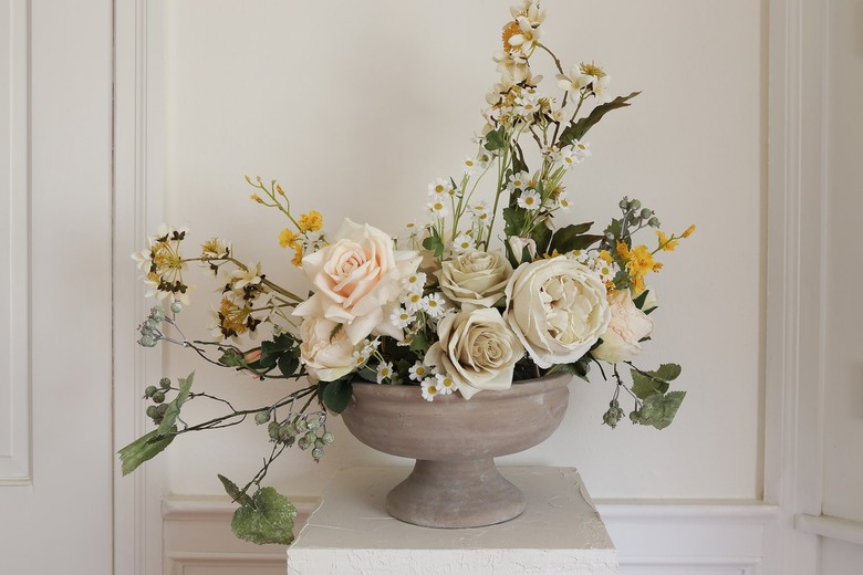 Mini daisy flowers placed inside center of floral arrangement