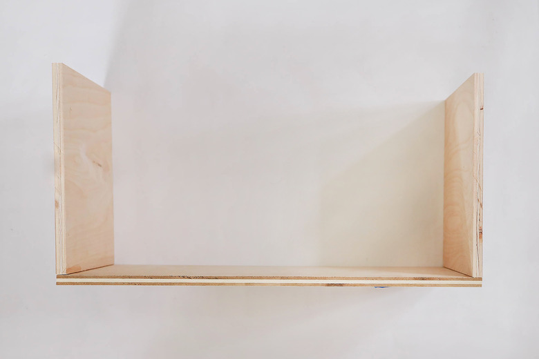 Three boards assembled into bottom floor of dollhouse