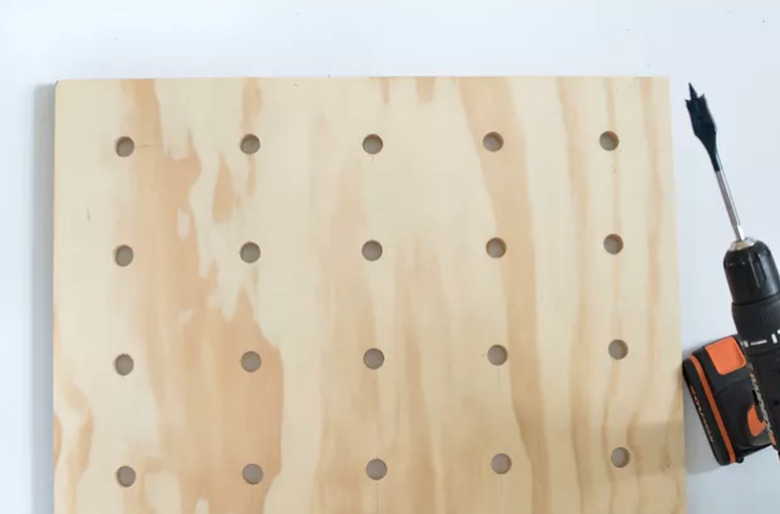 wood board with drilled holes for pegboard