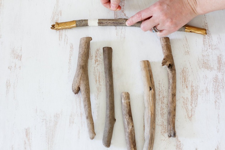 hanging vertical sticks are secured to a horizontal one with fishing line