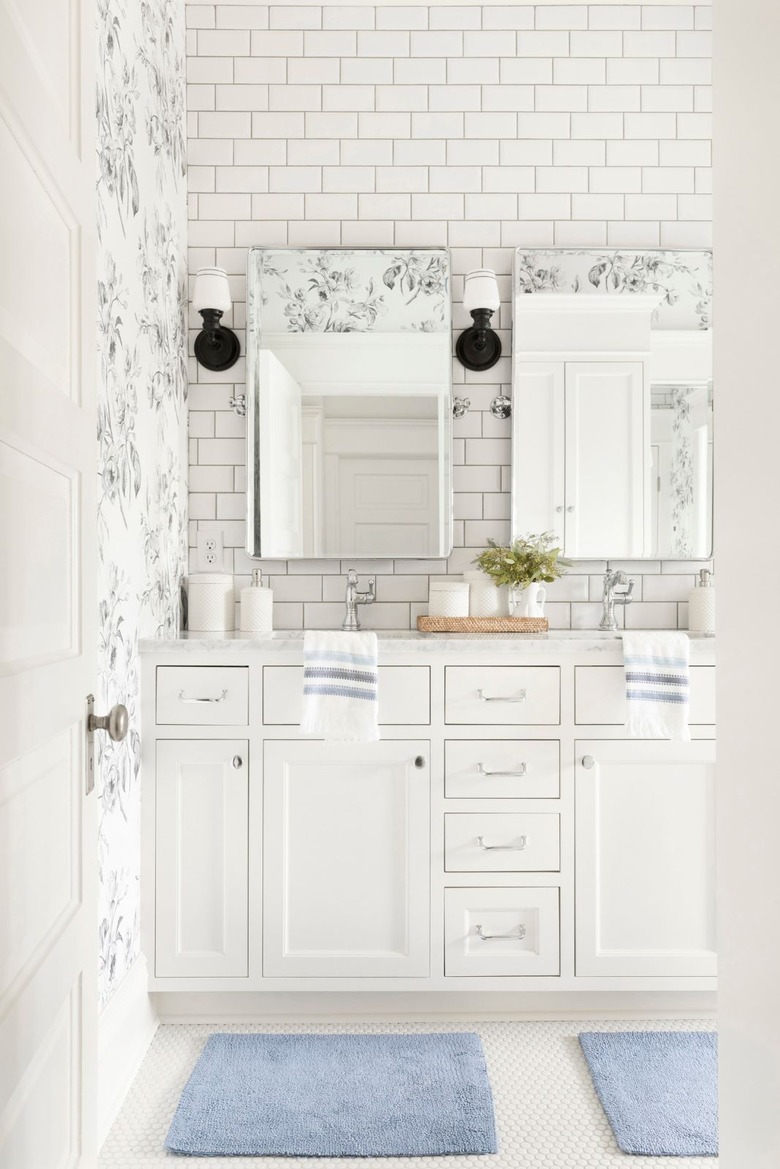 Double bathroom vanity with white cabinets and floral wallpaper