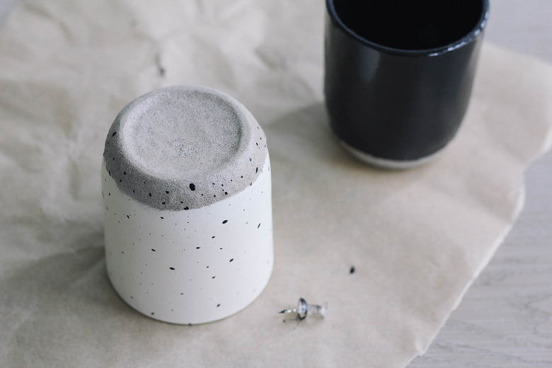 Painting speckled spots onto candle jar with thumbtack