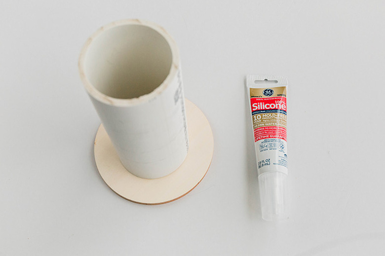 Attach the cut PVC pipe to the circles using silicone caulk.