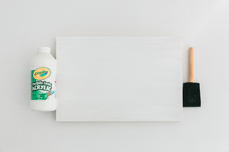 Paint the top of the largest piece of wood white.