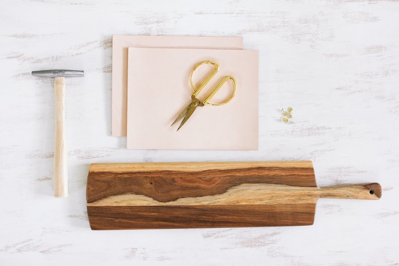 a paddle-shaped wooden cutting board