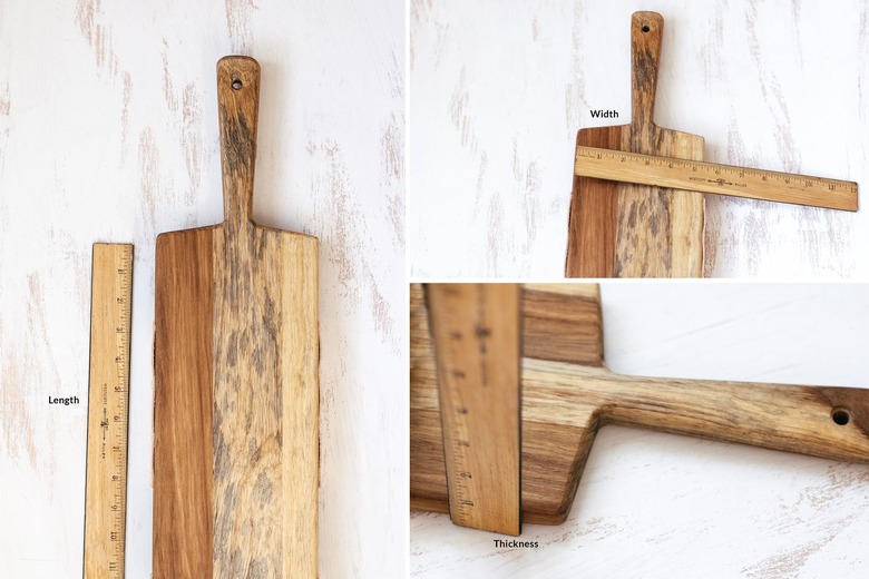 measuring a cutting board with a wooden ruler