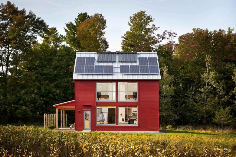 red eco-friendly modular home with solar panels