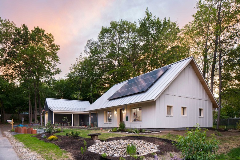 White eco-friendly modular home with solar panels
