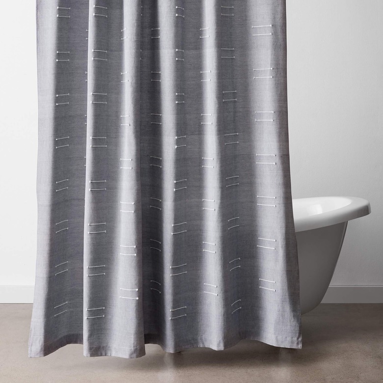 Embroidered gray eco-friendly shower curtain displayed in white bathroom