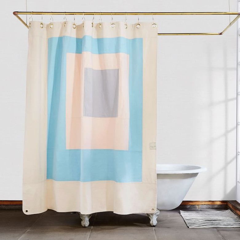 Blue and white eco-friendly shower curtain with modern design in white bathroom
