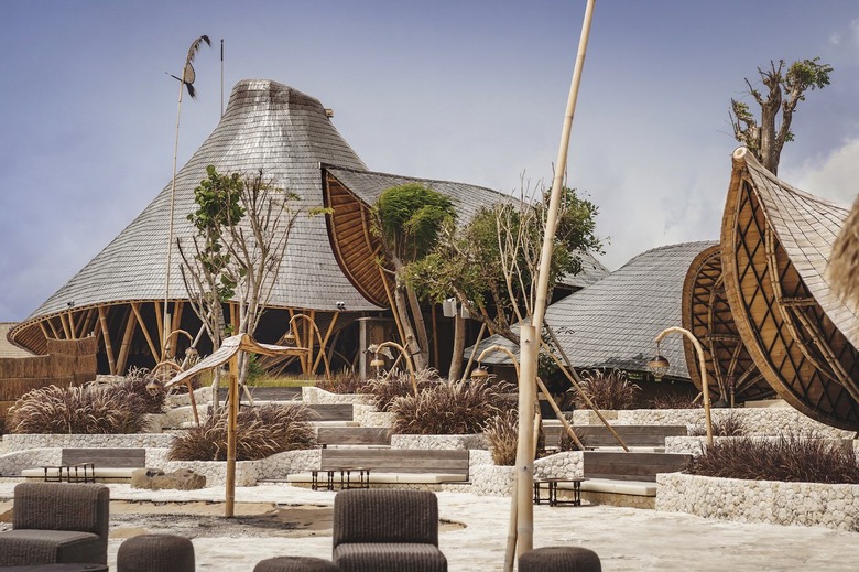 A beach club with bamboo buildings and long