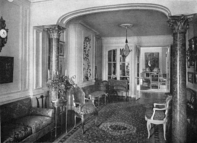 black and white photograph of interior with seating