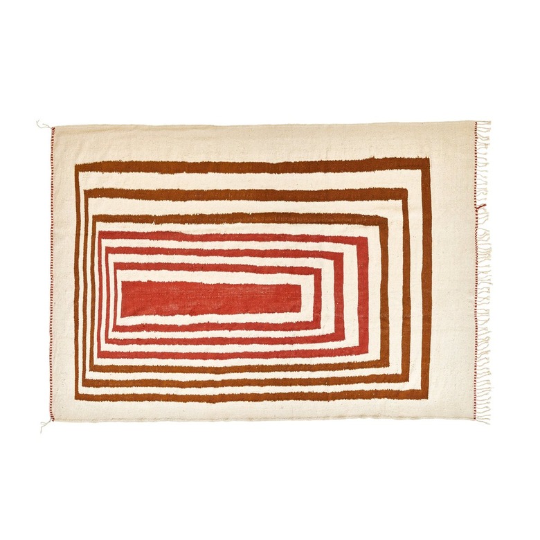 A cream colored rug with an orange and red concentric rectangle design