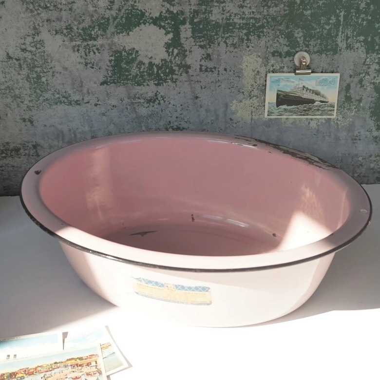 A vintage 1940s pink baby bathtub.