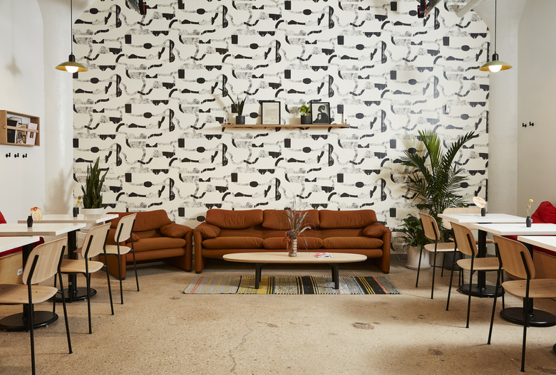 seating area with graphic black and white wallpaper