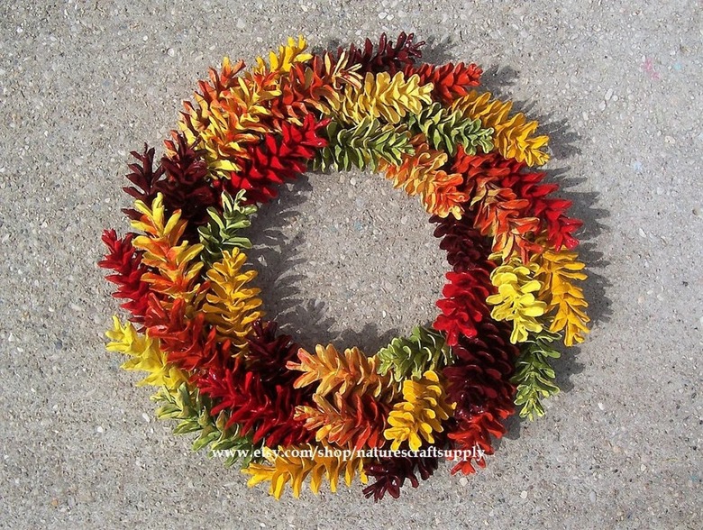 A red green yellow and brown pinecone wreath
