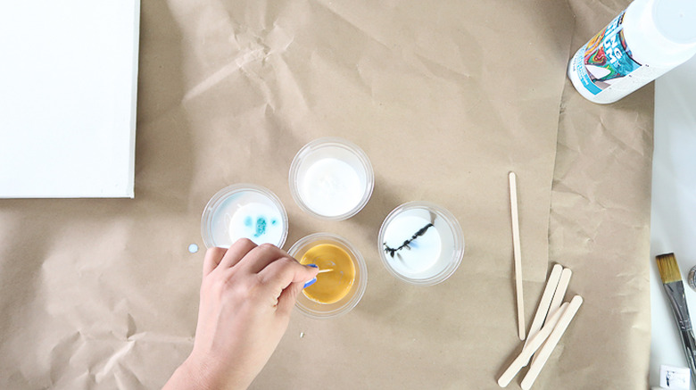 Mixing pouring medium and paint together.