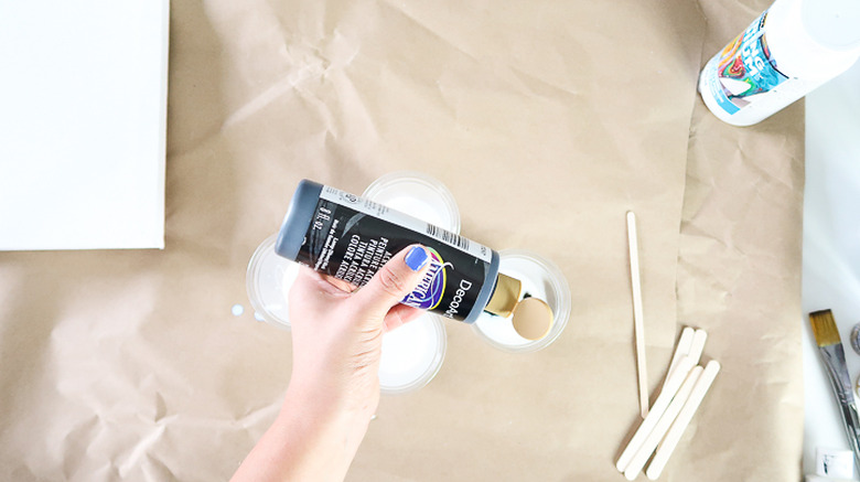 Paint being poured into cup.