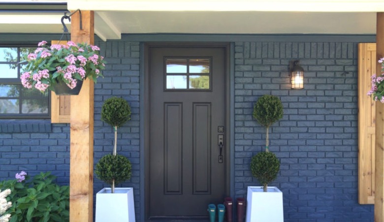 Navy blue brick home exterior with black window trim
