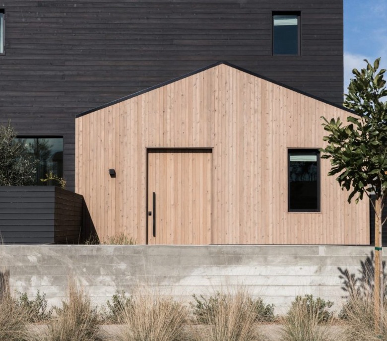 Modern home exterior with black and natural wood siding