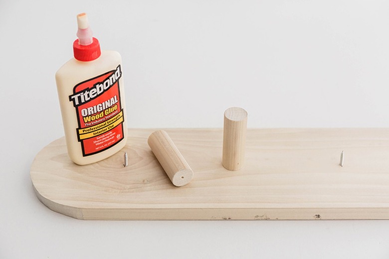 Pre-drill holes in the back end of the dowel rod hooks you made