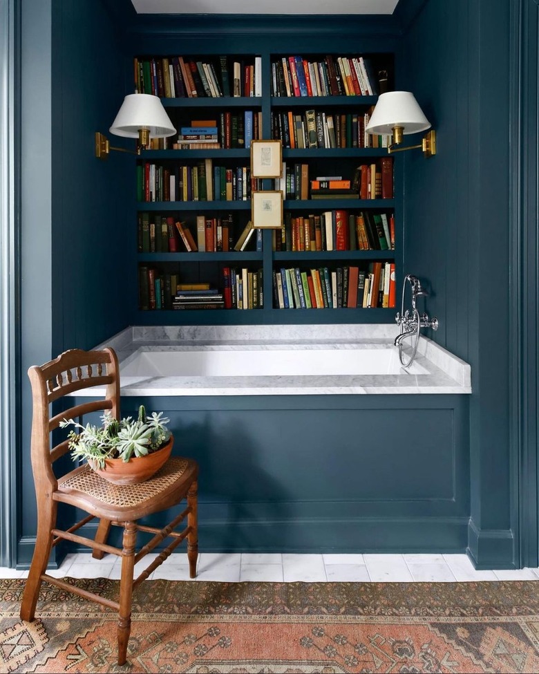 farmhouse bathroom idea with built-in library wall in blue