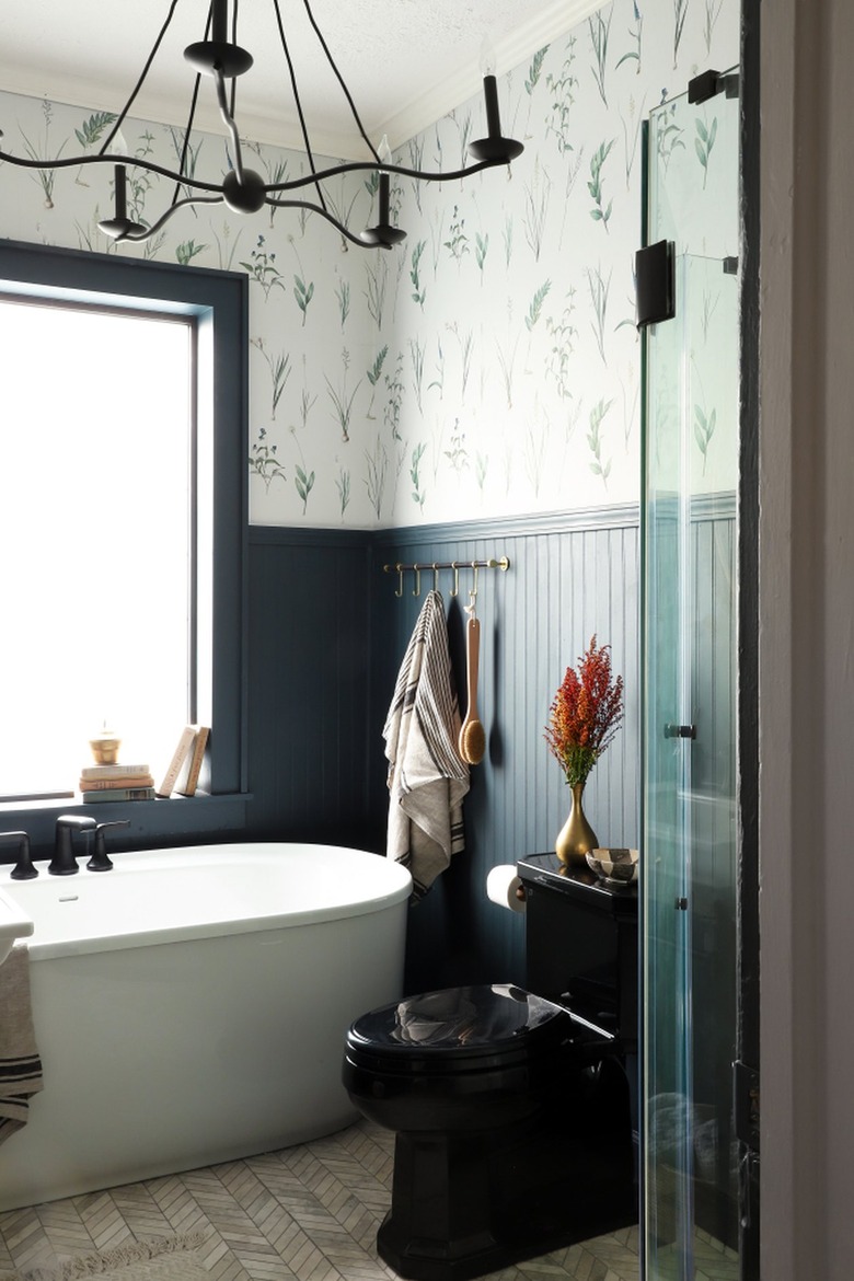 vintage farmhouse bathroom idea with blue shiplap walls and statement wallpaper