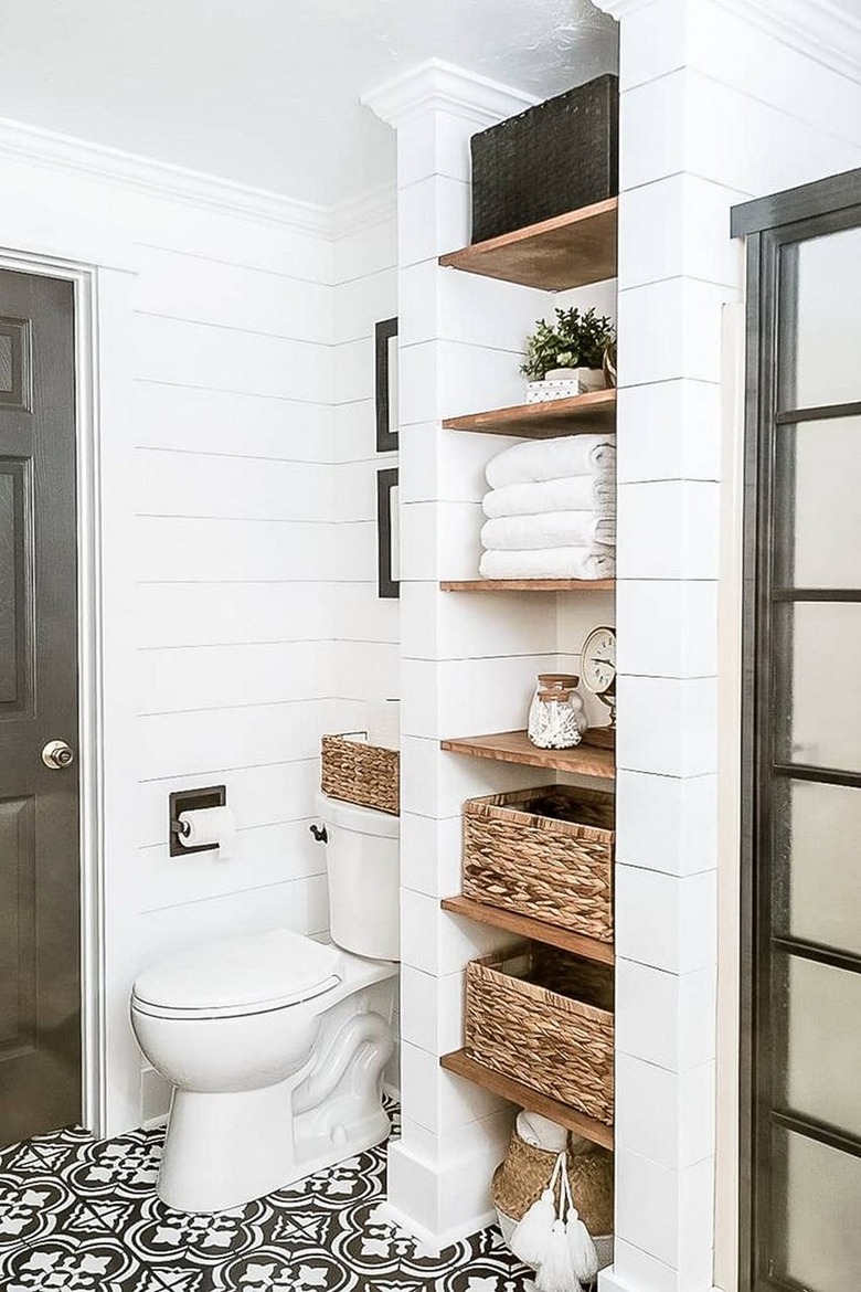 farmhouse bathroom idea with wooden shelving and black and white patterned floor