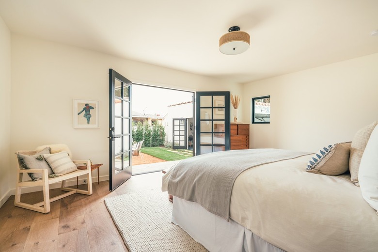 farmhouse bedroom with seating area next to French doors