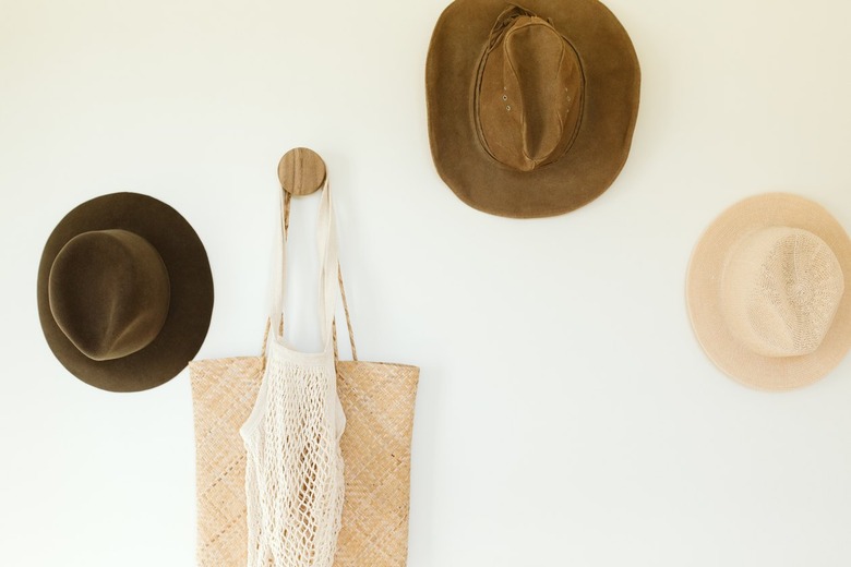 vintage hats hanging on a wall