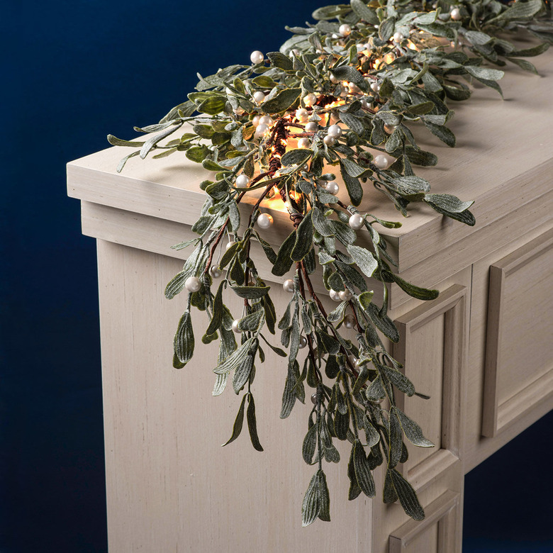 farmhouse Christmas decor with mistletoe garland with lights and pearly berries