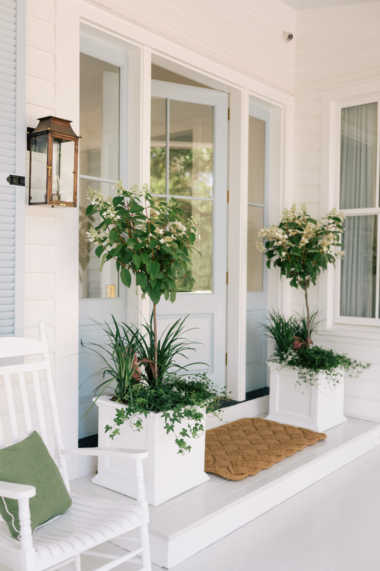 Farmhouse entryway with white planters