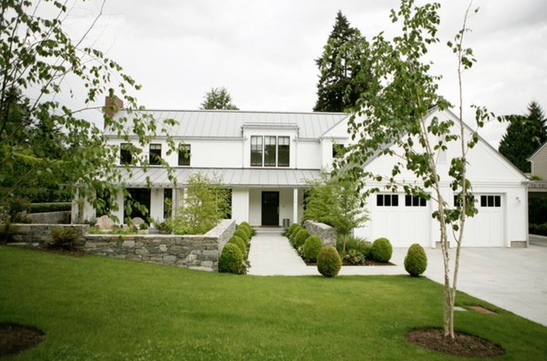 White farmhouse with front lawn