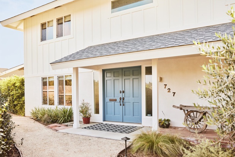 White farmhouse exterior with blue door