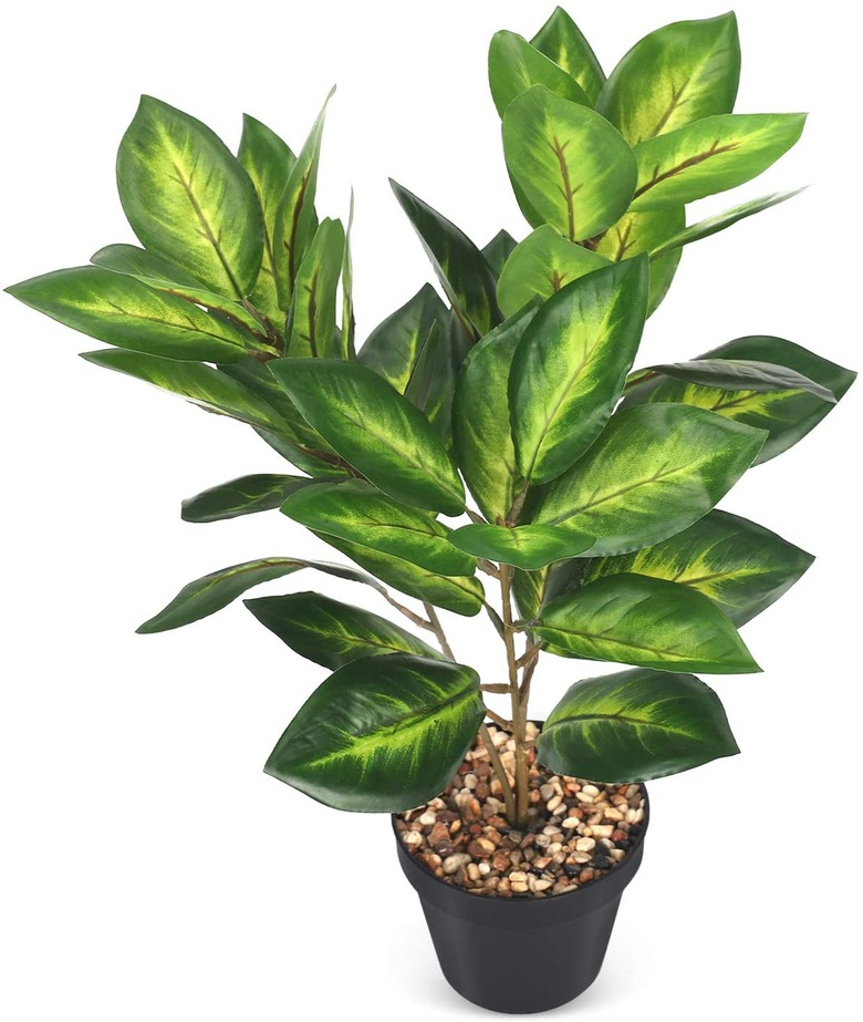 faux plant in black planter with pebbles