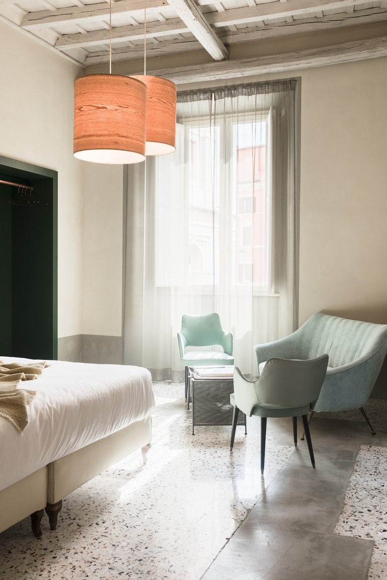Bedroom sitting area with light cyan chairs and white walls