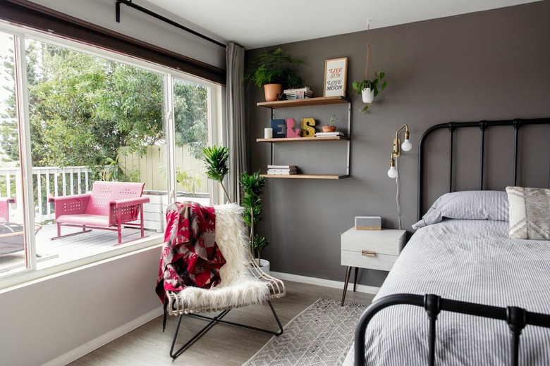Chair with white shag blanket under shelves
