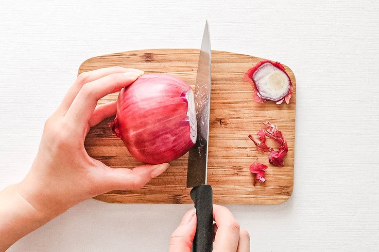 Cut off root and stem of onion
