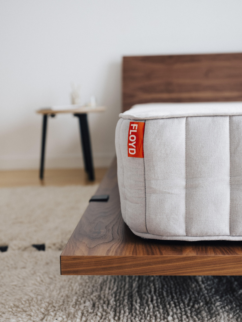 mattress on dark walnut platform bed