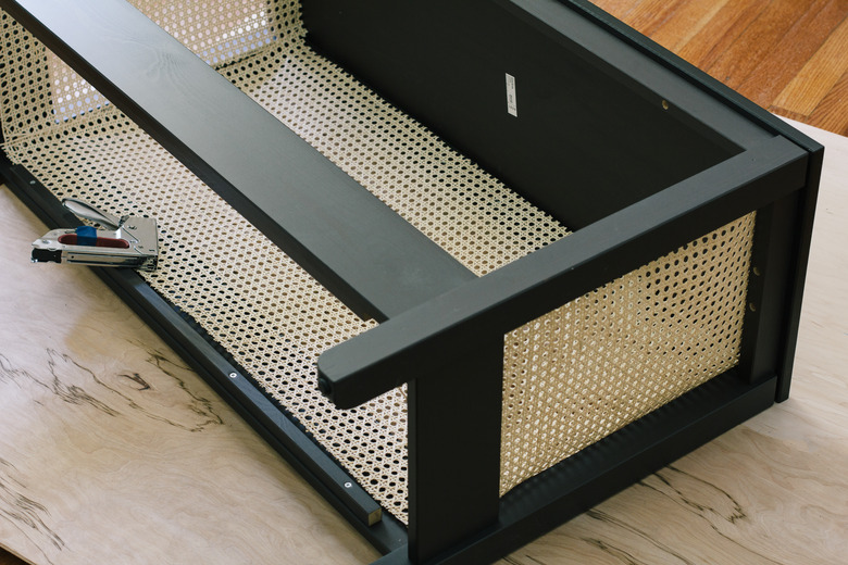Cane webbing stapled inside IKEA console table