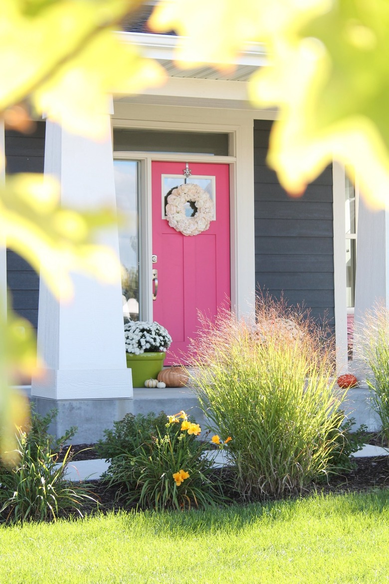 charcoal gray house with fuchsia door