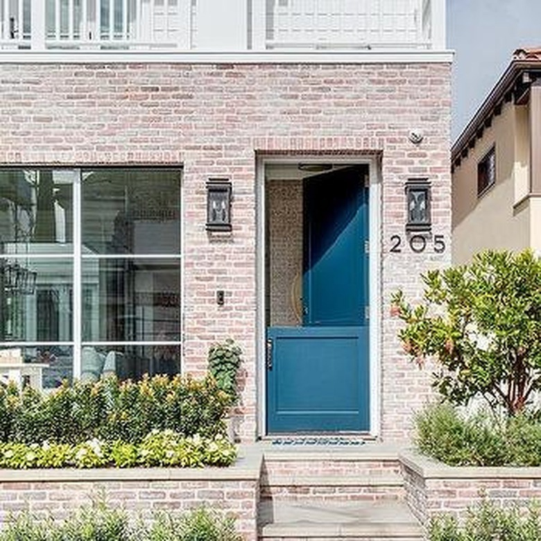 faded brick facade with navy Dutch door