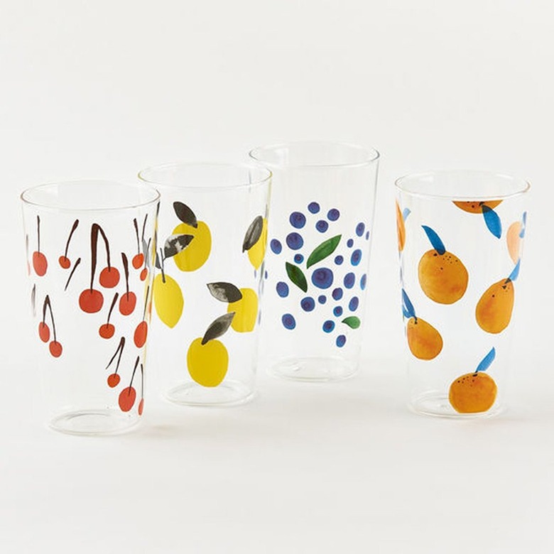four glass tumblers in various fruit patterns