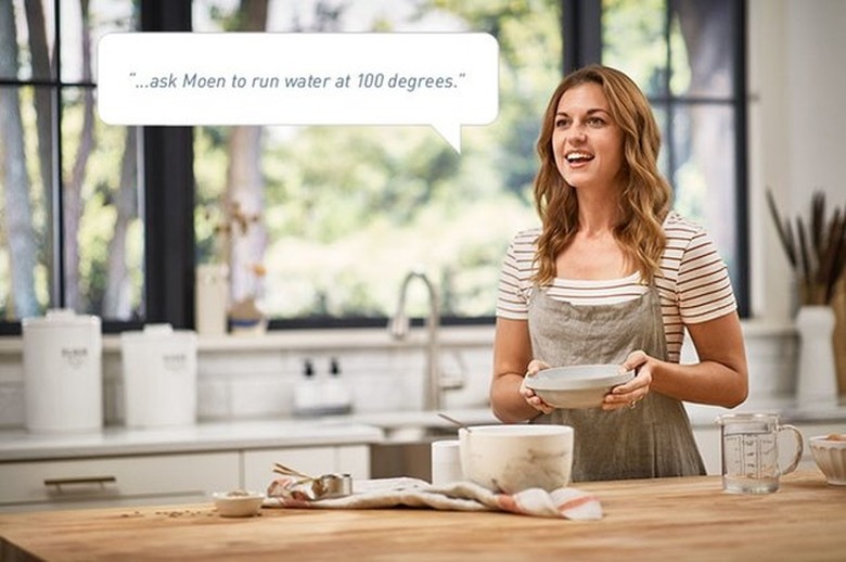 a woman in kitchen holding a bowl