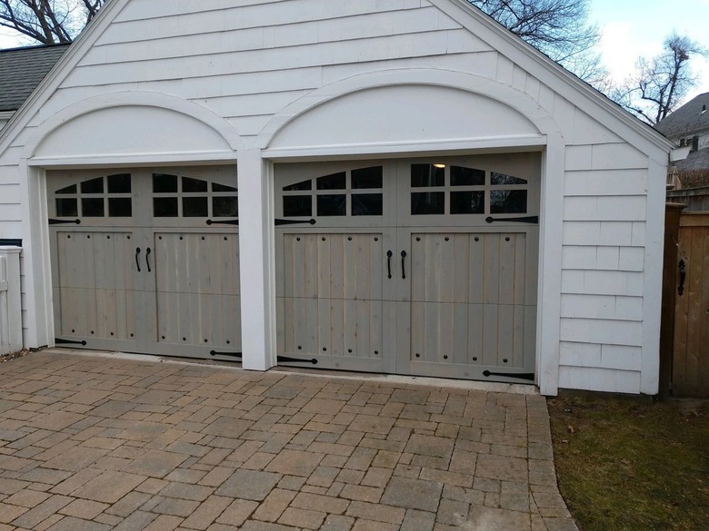 Wooden four-car garage that has carriage or swing-style opening
