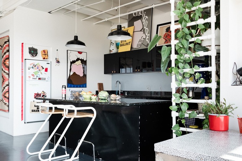 A kitchen with black cabinets
