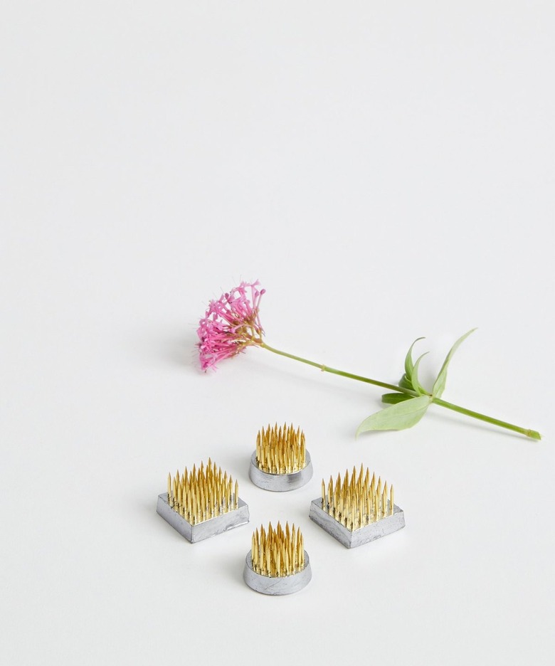 flower next to four ikebana kenzan also known as flower frogs