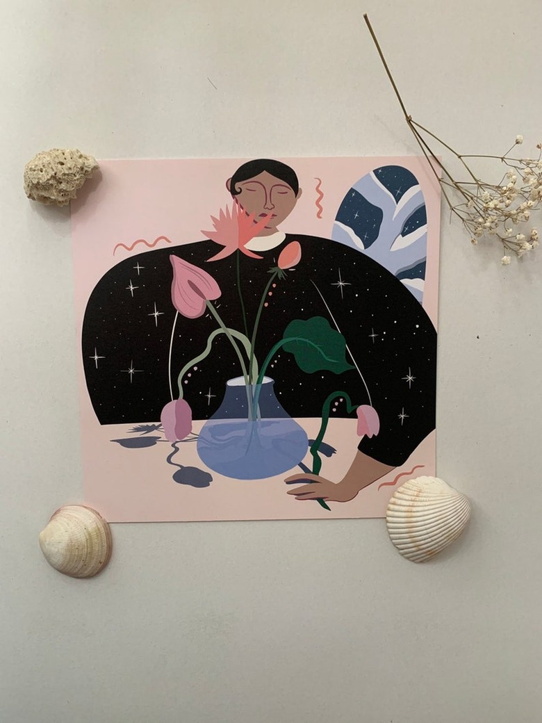 overhead photo of art print with shells and baby's breath nearby